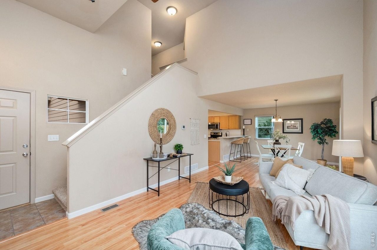 Open main level: living room in front, with the kitchen and dining area beyond