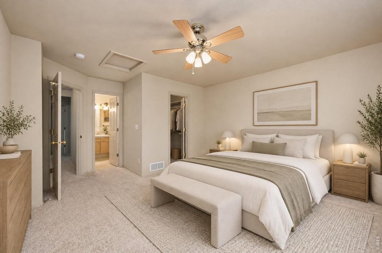 Primary bedroom with an open door to its private bath (virtually staged)